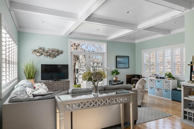 living area featuring beamed ceiling, wood finished floors, and coffered ceiling