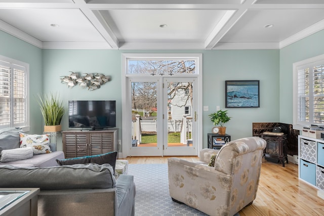 living room featuring light wood-type flooring, beam ceiling, ornamental molding, and coffered ceiling