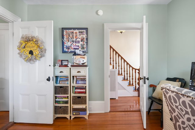corridor with stairs and wood finished floors