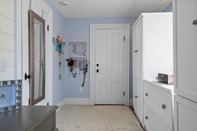 hall featuring baseboards