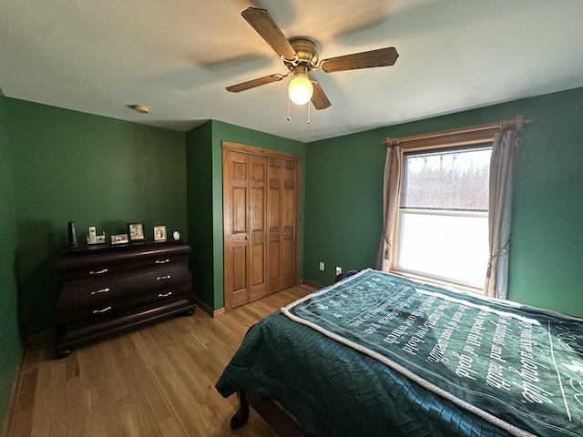 238 Moose Brook Rd, Ludlow, ME 04730 - bedroom featuring baseboards, wood finished floors, a closet, and ceiling fan