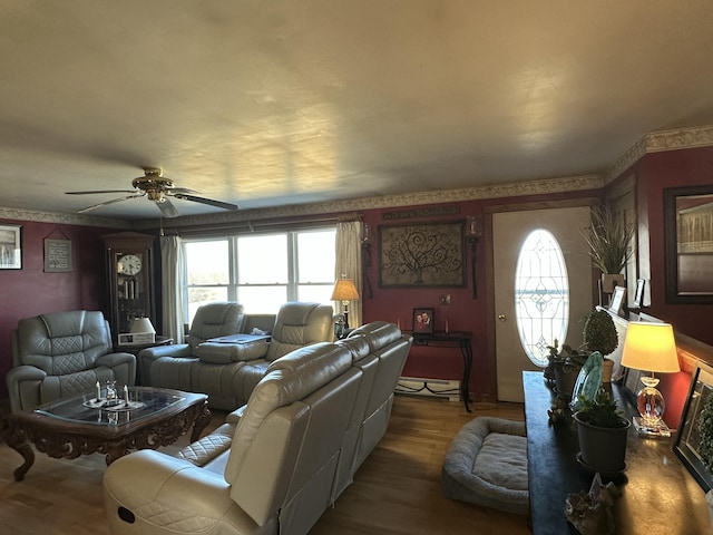 238 Moose Brook Rd, Ludlow, ME 04730 - living area featuring a baseboard radiator, wallpapered walls, wood finished floors, and ceiling fan