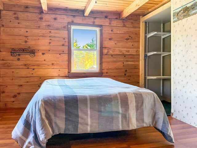 450 Greenwoods Rd, Peru, ME 04290 - bedroom featuring wallpapered walls, wooden ceiling, wood finished floors, and beam ceiling