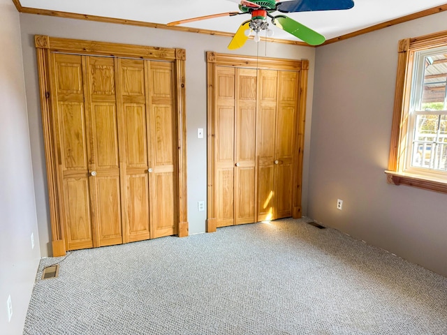 450 Greenwoods Rd, Peru, ME 04290 - unfurnished bedroom with ceiling fan, visible vents, carpet floors, and two closets