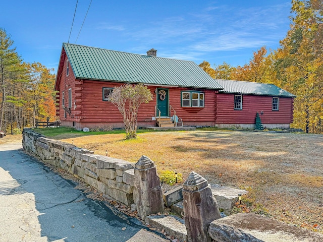 450 Greenwoods Rd, Peru, ME 04290 - log-style house with a chimney, metal roof, log siding, entry steps, and crawl space