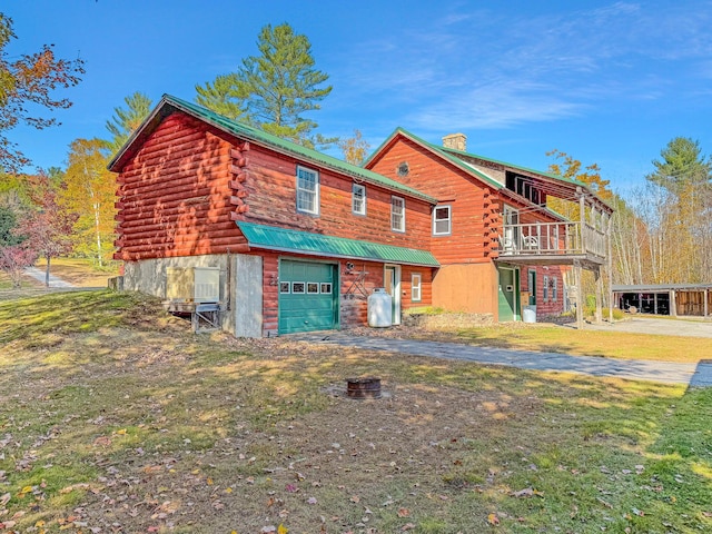 450 Greenwoods Rd, Peru, ME 04290 - exterior space featuring a chimney, log exterior, an attached garage, driveway, and a front yard