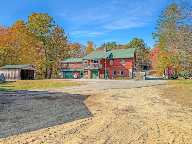 450 Greenwoods Rd, Peru, ME 04290 - view of front of house featuring driveway, a chimney, and metal roof