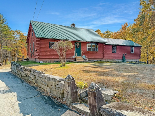 450 Greenwoods Rd, Peru, ME 04290 - log home with a chimney, metal roof, log exterior, entry steps, and crawl space
