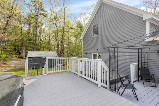 wooden deck featuring an outdoor structure and a shed