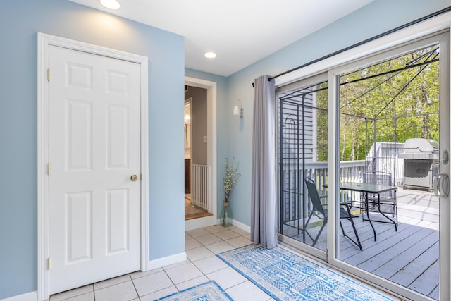 entryway featuring baseboards, light tile patterned floors, and recessed lighting