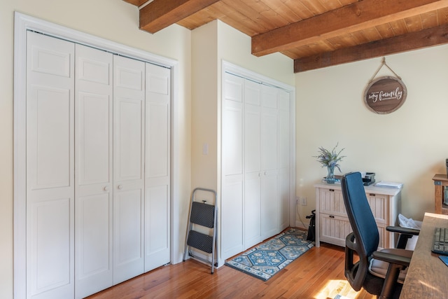 office space with light wood-type flooring, beam ceiling, and wooden ceiling