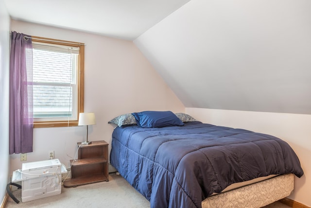 carpeted bedroom featuring lofted ceiling