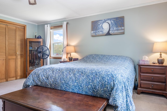 carpeted bedroom featuring crown molding and a closet