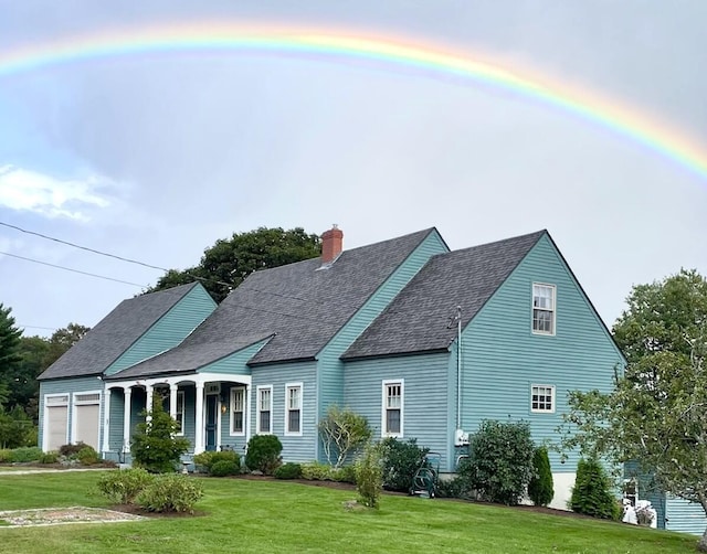 18 Pleasant St, Newcastle, ME 04553 - cape cod house with a front lawn, a garage, a chimney, roof with shingles, and a porch