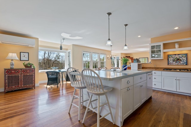 18 Pleasant St, Newcastle, ME 04553 - kitchen with a wall mounted AC, a sink, dark wood-type flooring, a kitchen bar, and recessed lighting