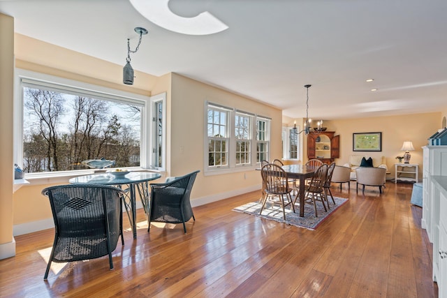 18 Pleasant St, Newcastle, ME 04553 - dining space with a chandelier, wood-type flooring, and baseboards