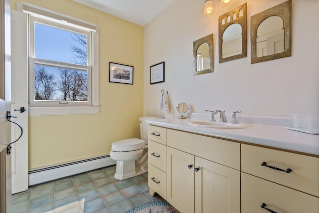 18 Pleasant St, Newcastle, ME 04553 - bathroom with a baseboard heating unit, vanity, and toilet