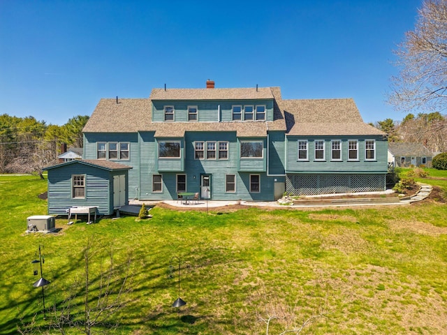 18 Pleasant St, Newcastle, ME 04553 - rear view of house featuring a yard, a patio area, and a chimney