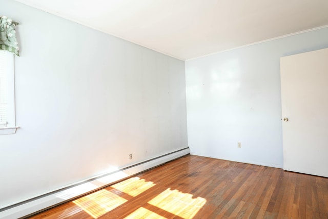 24 Lincoln St, Ellsworth, ME 04605 - spare room featuring ornamental molding, wood-type flooring, and a baseboard heating unit