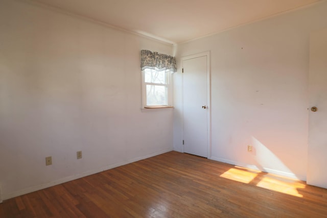24 Lincoln St, Ellsworth, ME 04605 - empty room featuring ornamental molding, baseboards, and wood finished floors