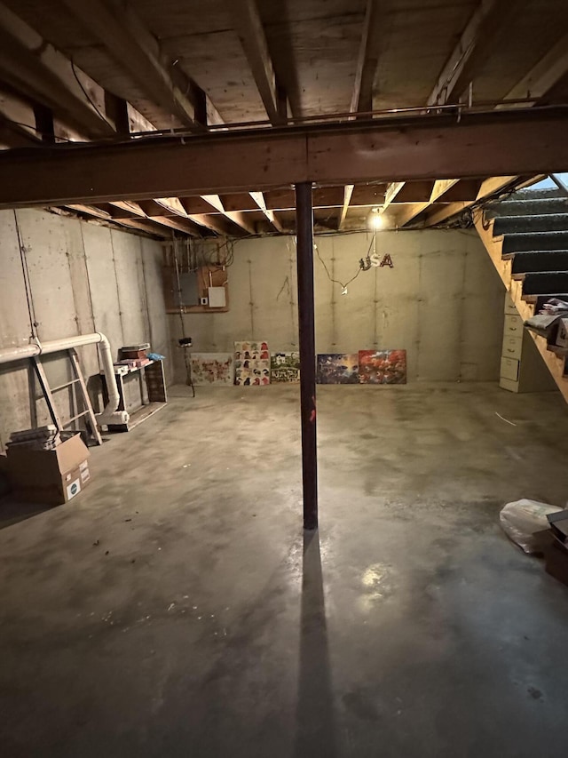 unfinished below grade area featuring stairway