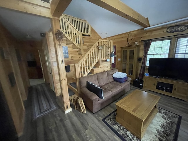 living room with wooden walls, lofted ceiling with beams, stairs, and wood finished floors