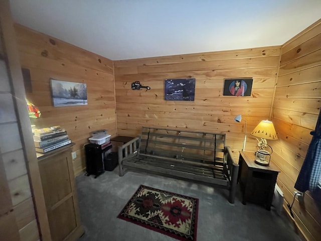 living area featuring carpet floors and wood walls