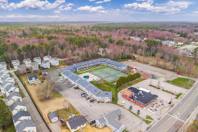 birds eye view of property featuring a view of trees