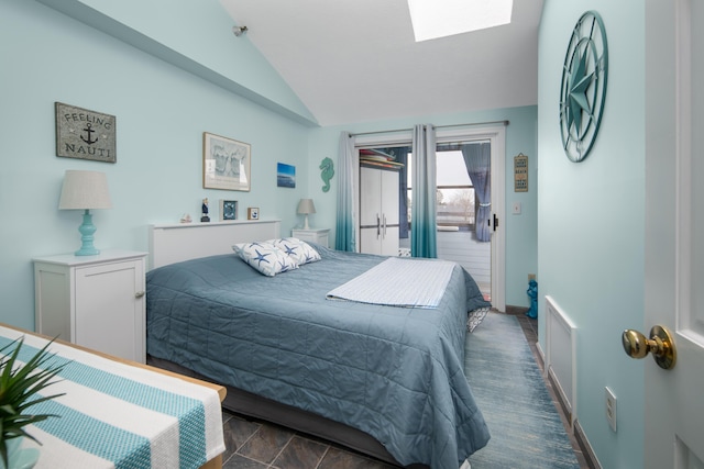 bedroom with lofted ceiling with skylight and access to exterior