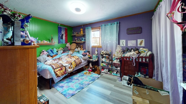 195 Rim Rd, East Machias, ME 04630 - bedroom featuring wood finished floors, a textured ceiling, and ornamental molding