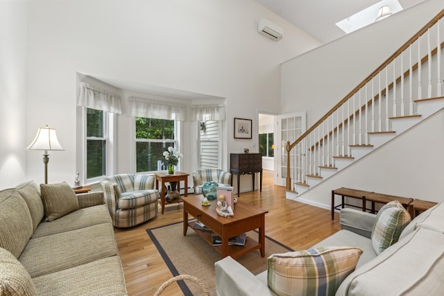 48 Windward Pointe Dr Unit 48, Wells, ME 04090 - living area with stairway, a skylight, a high ceiling, and light wood-style flooring