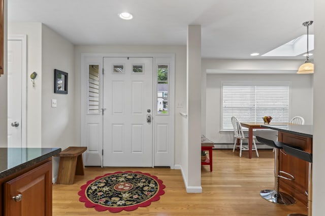 48 Windward Pointe Dr Unit 48, Wells, ME 04090 - foyer entrance featuring a skylight, recessed lighting, baseboard heating, baseboards, and light wood-style floors