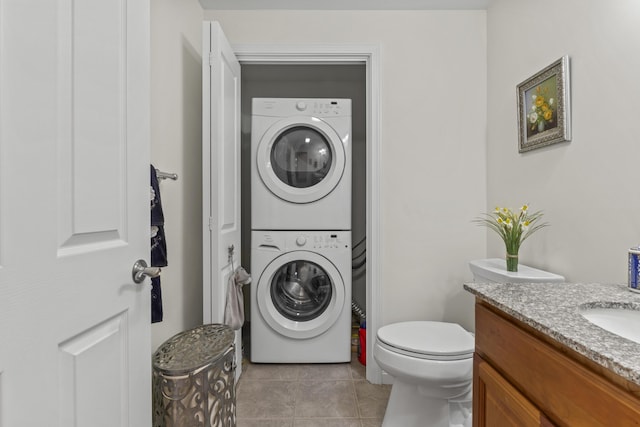 48 Windward Pointe Dr Unit 48, Wells, ME 04090 - clothes washing area featuring stacked washing maching and dryer, laundry area, and light tile patterned flooring
