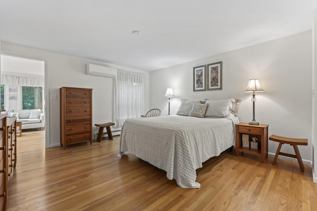 48 Windward Pointe Dr Unit 48, Wells, ME 04090 - bedroom with baseboards, light wood finished floors, and a wall mounted air conditioner