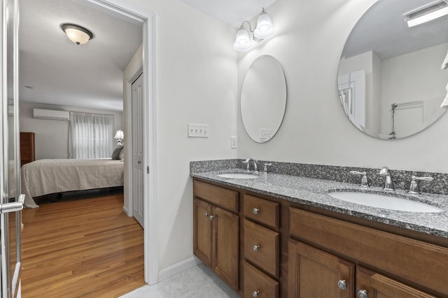 48 Windward Pointe Dr Unit 48, Wells, ME 04090 - ensuite bathroom featuring a sink, double vanity, an AC wall unit, and visible vents
