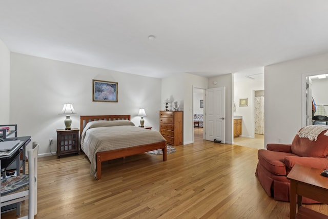 48 Windward Pointe Dr Unit 48, Wells, ME 04090 - bedroom featuring light wood-style flooring, connected bathroom, and baseboards