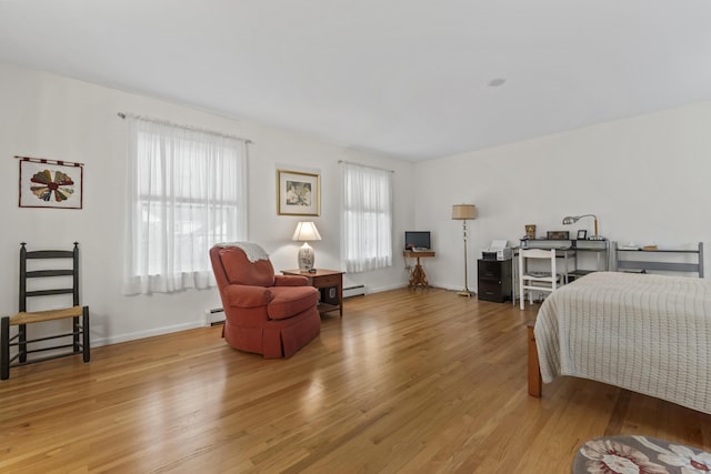 48 Windward Pointe Dr Unit 48, Wells, ME 04090 - bedroom with light wood-style floors, baseboards, baseboard heating, and a baseboard heating unit