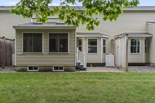 48 Windward Pointe Dr Unit 48, Wells, ME 04090 - rear view of house featuring a lawn, a patio, fence, and entry steps