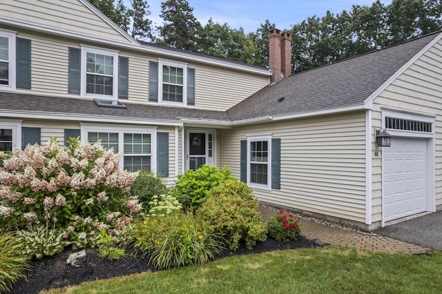 48 Windward Pointe Dr Unit 48, Wells, ME 04090 - exterior space featuring a chimney, roof with shingles, and a garage