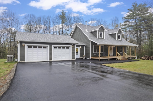 52 Birch Ests, Rome, ME 04963 - view of front facade with covered porch, asphalt driveway, an attached garage, central AC unit, and a shingled roof