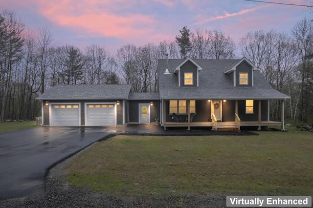 52 Birch Ests, Rome, ME 04963 - view of front of property featuring asphalt driveway, a garage, a porch, a lawn, and roof with shingles