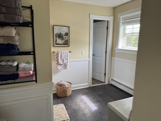 bathroom with a baseboard heating unit and vanity
