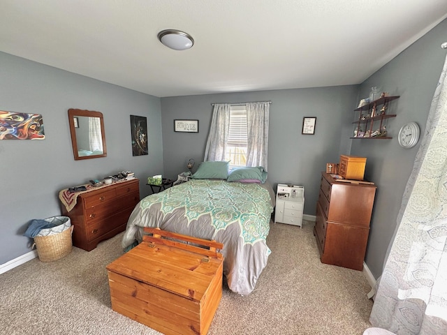 bedroom with light carpet and baseboards