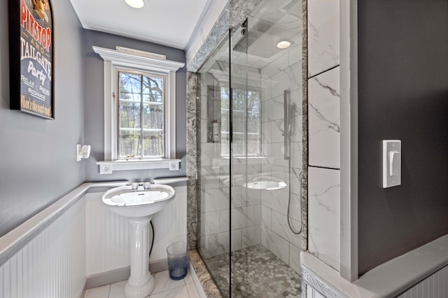 bathroom with tile patterned floors and a stall shower