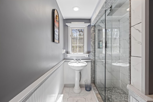 full bath featuring a marble finish shower