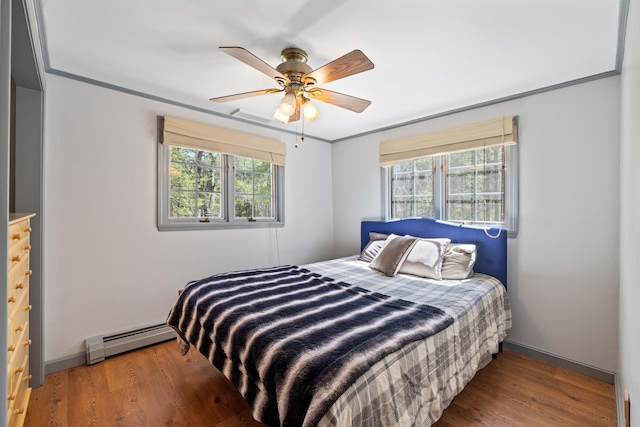 bedroom featuring baseboards, a baseboard radiator, a ceiling fan, and wood finished floors