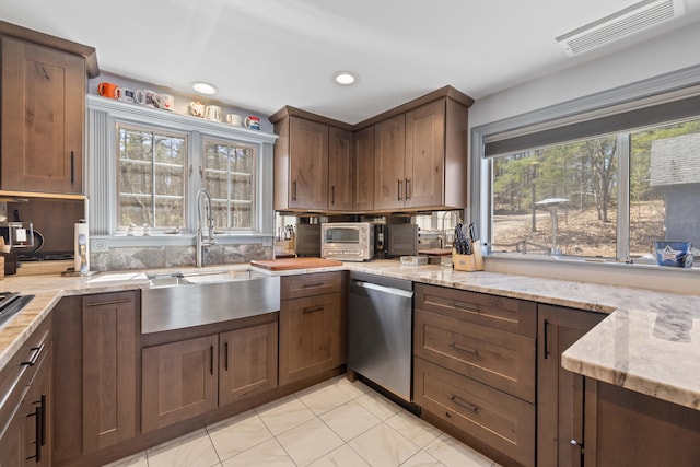 kitchen featuring visible vents, dishwasher, a sink, light stone counters, and recessed lighting