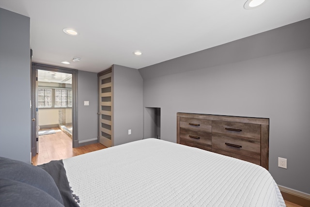 bedroom featuring baseboards, recessed lighting, and wood finished floors