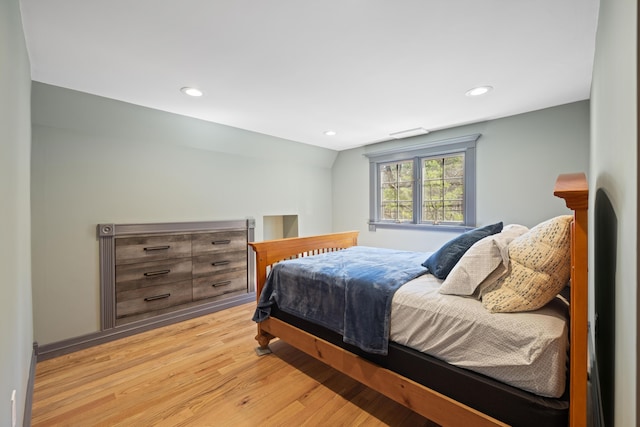 bedroom with recessed lighting, vaulted ceiling, and light wood finished floors