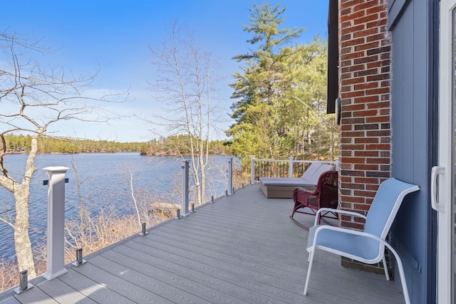 wooden terrace featuring a water view and a dock